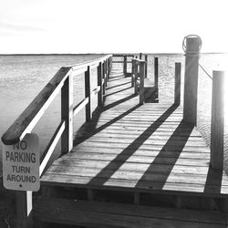 Close-up of railing on beach against clear sky