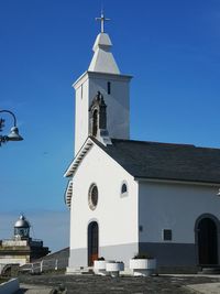 Low angle view of church against clear blue sky