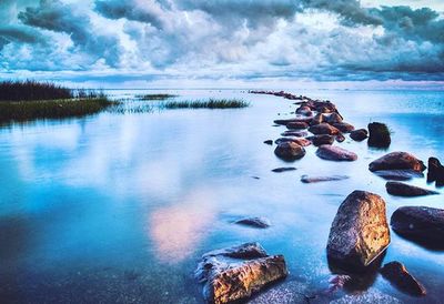 Scenic view of sea against cloudy sky