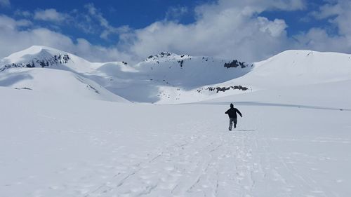 People walking on snow covered landscape