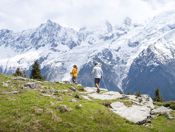 Couple hiking near snowcapped mountains