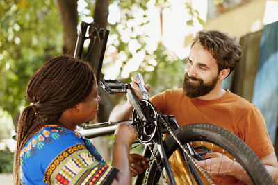 Side view of young man riding bicycle