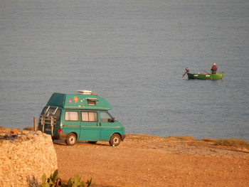 High angle view of men sitting on shore