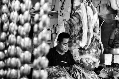 Full length of boy standing at market stall