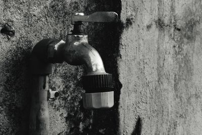 Close-up of faucet in water