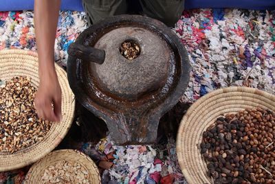 Midsection of man grinding spices