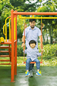 Full length of father with son at playground