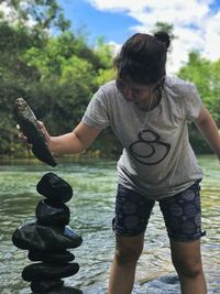 Full length of young woman against sky