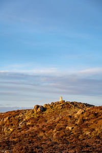 Scenic view of rocks on sea against sky