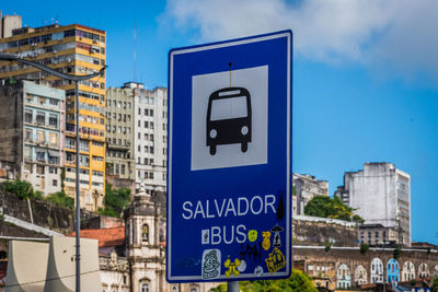 Close-up of information sign against blue sky
