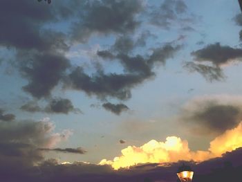 Low angle view of silhouette building against dramatic sky