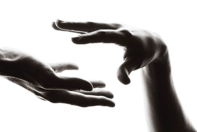 Close-up of hand touching finger against white background