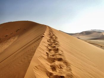 Idyllic shot of sand dune against clear sky at namib desert