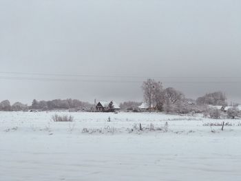 Scenic view of snow covered land against clear sky