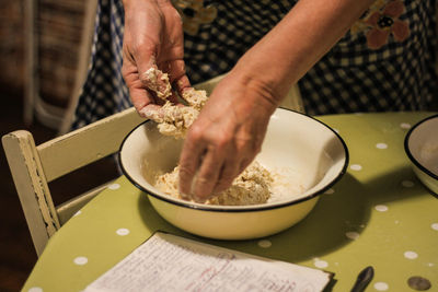 Midsection of man preparing food on table