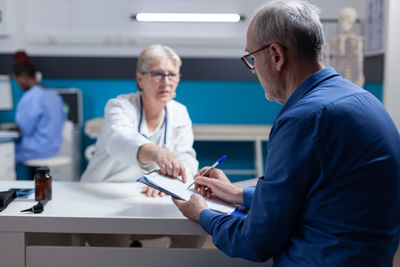 Doctor getting document signed by patient