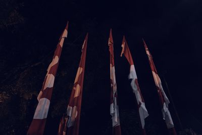 Low angle view of flags hanging against the sky