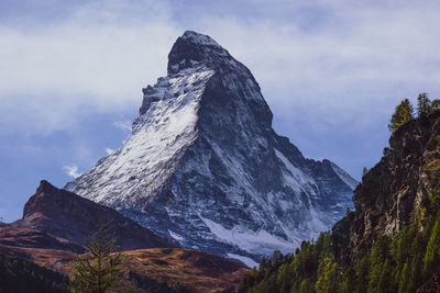 Low angle view of snowcapped mountain against sky