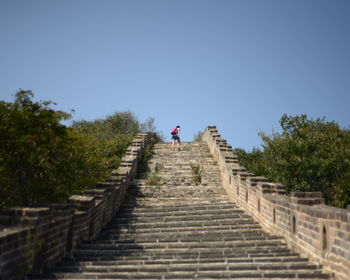 Woman at great wall of china against clear sky