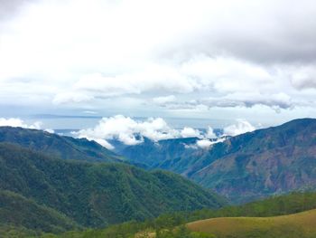 Scenic view of mountains against cloudy sky