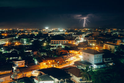 High angle view of illuminated cityscape against sky at night