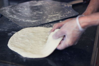 Close-up of hand holding pizza