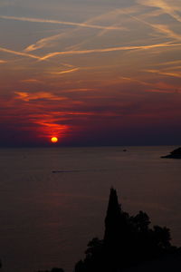 Scenic view of sea against romantic sky at sunset