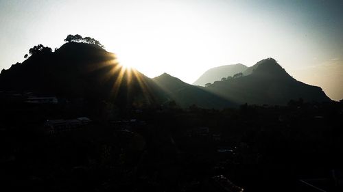 Silhouette mountains against clear sky