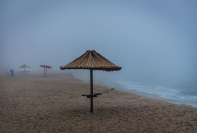 Lifeguard hut on beach against sky