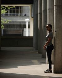 Full length of woman standing on railing