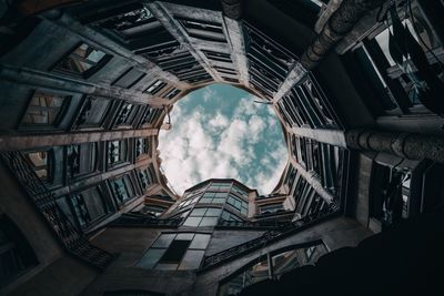 Low angle view of building against cloudy sky