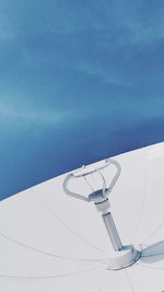 Low angle view of telephone pole against blue sky