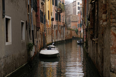 Typical narrow street with historical houses between the canals in venice, italy.