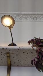 Close-up of illuminated lamp on table