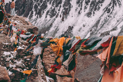 Close-up of multi colored umbrellas hanging on rock