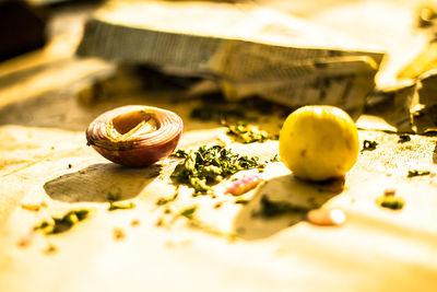 Close-up of onion and lemon on table