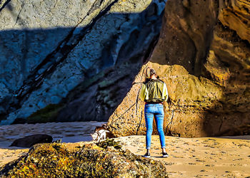 Rear view of man standing on rock