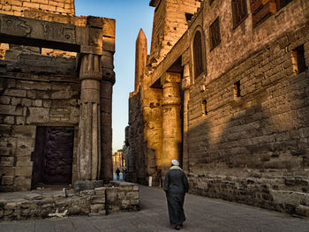 Rear view of man walking in old ruin