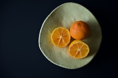 Close-up of orange fruit against black background