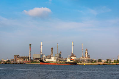 Commercial dock by sea against sky