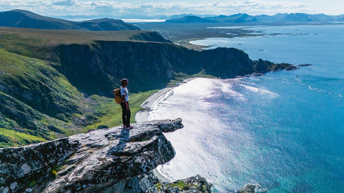 Rear view of man standing on mountain