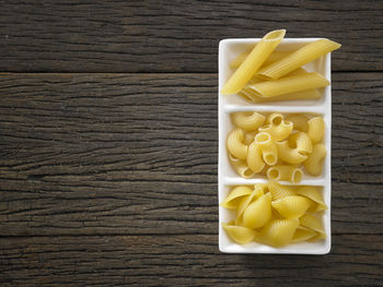 Close-up of colorful fusilli pasta in container on table