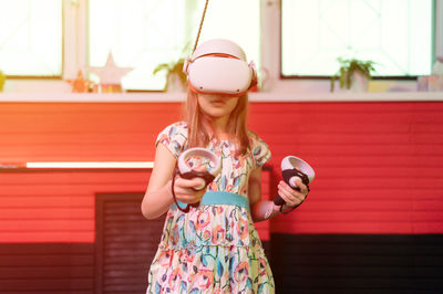 Vr game virtual reality. kid girl gamer playing on futuristic simulation video game in 3d glasses