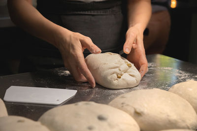 Baker making bread, female hands, kneading dough, cooking