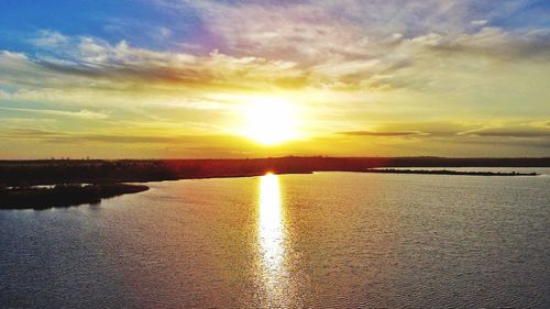 Scenic view of lake against sky during sunset