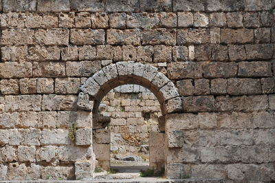 Stone wall of historic old ruins in city