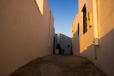 Narrow alley amidst buildings in town