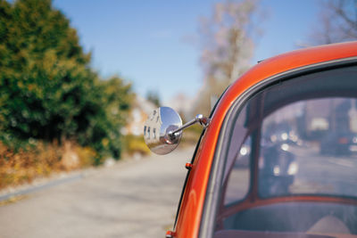 Close up of orange oldtimer on street
