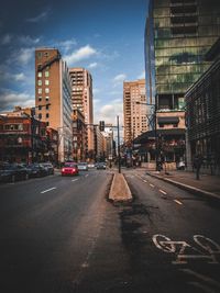 City street and buildings against sky