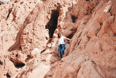 Woman standing on rock formation